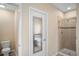 Bright bathroom featuring a glass-enclosed shower, soaking tub, and neutral color scheme at 1688 Tamarind Rd, Davenport, FL 33896