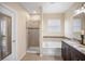 Well-lit bathroom with a walk-in shower, soaking tub, and vanity with double sinks and granite countertops at 1688 Tamarind Rd, Davenport, FL 33896
