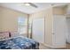 Bedroom with ceiling fan, closet, and a window bringing in lots of natural light at 1688 Tamarind Rd, Davenport, FL 33896