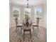 Charming dining area featuring lots of light from bay windows and classic furniture at 1688 Tamarind Rd, Davenport, FL 33896