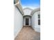 Inviting front entry showcasing a brick walkway and a covered porch at 1688 Tamarind Rd, Davenport, FL 33896