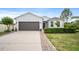 Charming single-story home featuring a well-manicured lawn and a spacious driveway at 1688 Tamarind Rd, Davenport, FL 33896