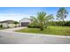 A beautiful single story house with well-manicured green grass and a paved driveway at 1688 Tamarind Rd, Davenport, FL 33896