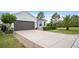 A beautiful house with a paved driveway and manicured lawn in a lovely neighborhood at 1688 Tamarind Rd, Davenport, FL 33896