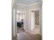 Hallway leading to bedroom and bathroom with tile flooring and neutral paint at 1688 Tamarind Rd, Davenport, FL 33896