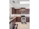 Stylish kitchen with stainless steel appliances, granite counters, and dark wood cabinets at 1688 Tamarind Rd, Davenport, FL 33896