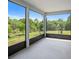 Screened-in lanai providing expansive views of the backyard at 1688 Tamarind Rd, Davenport, FL 33896