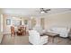 Open living area showcasing a dining nook, white sofas, ceiling fan, and neutral color palette at 1688 Tamarind Rd, Davenport, FL 33896