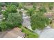 Residential area showcasing a single-Gathering home, surrounded by lush trees and mature landscaping in a suburban community at 17 Juniper Dr, Davenport, FL 33837
