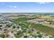 Expansive community aerial view featuring residential neighborhoods, green spaces, and commercial areas in a thriving city at 17 Juniper Dr, Davenport, FL 33837