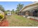 Well-maintained backyard featuring green grass, mulch beds, and a small shed, ideal for gardening or outdoor activities at 17 Juniper Dr, Davenport, FL 33837
