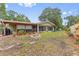 Charming home backyard featuring a stone fire pit and screened-in porch, perfect for outdoor relaxation and entertaining at 17 Juniper Dr, Davenport, FL 33837
