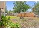 Spacious backyard with a fire pit, wooden fence, and green foliage at 17 Juniper Dr, Davenport, FL 33837