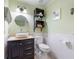 Bathroom with storage shelves, vanity sink, and updated toilet at 17 Juniper Dr, Davenport, FL 33837