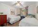 Bedroom with hardwood floors, ceiling fan, and natural light at 17 Juniper Dr, Davenport, FL 33837