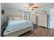 Bright, well-lit bedroom featuring light blue walls, wood-look flooring, and stylish dressers at 17 Juniper Dr, Davenport, FL 33837