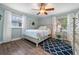 Comfortable bedroom with soft blue walls, wood-look flooring, and a light-colored bed frame at 17 Juniper Dr, Davenport, FL 33837