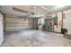 Spacious garage with ample room for parking and storage, complete with workbench area and overhead lighting at 17 Juniper Dr, Davenport, FL 33837