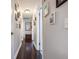 Hallway with hardwood floors, neutral walls, and framed photographs at 17 Juniper Dr, Davenport, FL 33837