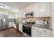 Updated kitchen features stainless steel appliances, granite countertops, and subway tile backsplash at 17 Juniper Dr, Davenport, FL 33837