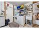 Practical laundry room with washer, dryer, utility sink, and ample shelving for storage and organization at 17 Juniper Dr, Davenport, FL 33837