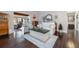 Bright living room with hardwood floors, white sofa, decorative mirror, and entryway views at 17 Juniper Dr, Davenport, FL 33837