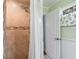 Shower features tiled walls and showerhead, complemented by a doorway with natural light at 17 Juniper Dr, Davenport, FL 33837