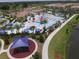 Aerial view of the community pool, playground, walking path, and surrounding townhome buildings at 2147 Tripoli Ct, Kissimmee, FL 34747