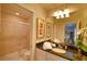 Well-lit bathroom featuring a walk-in shower, granite counters, and modern fixtures for a luxurious experience at 2147 Tripoli Ct, Kissimmee, FL 34747