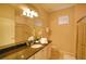 Bright bathroom features a vanity with granite countertop, glass enclosed shower, and natural lighting at 2147 Tripoli Ct, Kissimmee, FL 34747