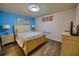 Bright bedroom featuring wood-look floors, a queen bed, and stylish decor that creates a relaxing ambiance at 2147 Tripoli Ct, Kissimmee, FL 34747