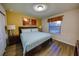 Comfortable bedroom featuring wood-look floors, a king bed, and stylish decor that creates a relaxing ambiance at 2147 Tripoli Ct, Kissimmee, FL 34747
