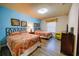 Inviting bedroom with two beds, wood-style flooring, and colorful decor at 2147 Tripoli Ct, Kissimmee, FL 34747