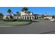 Well-manicured entrance to the clubhouse with palm trees, a fountain, and ample parking at 2147 Tripoli Ct, Kissimmee, FL 34747