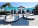 Community bar and lounge area with comfortable seating, umbrellas, and stylish decor, ideal for socializing at 2147 Tripoli Ct, Kissimmee, FL 34747