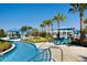Resort-style pool area with cabanas, lounge chairs, and palm trees, creating a luxurious vacation experience at 2147 Tripoli Ct, Kissimmee, FL 34747