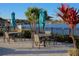 Charming outdoor seating area with tables and umbrellas, set against a backdrop of a serene lake with a water fountain at 2147 Tripoli Ct, Kissimmee, FL 34747