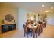 Bright dining room with decorative buffet, long table, and stylish decor, perfect for entertaining guests at 2147 Tripoli Ct, Kissimmee, FL 34747