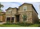 Stunning two-story home featuring a stone facade, well-maintained landscaping, and a two-car garage at 2147 Tripoli Ct, Kissimmee, FL 34747