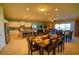Open-concept living space with a modern kitchen, dining area, and living room, ideal for Gathering gatherings and entertaining at 2147 Tripoli Ct, Kissimmee, FL 34747