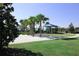 Community playground area surrounded by palm trees and well-maintained landscaping, offering a fun space for children at 2147 Tripoli Ct, Kissimmee, FL 34747