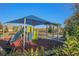 Community playground with a slide, climbing structure, and shade, perfect for children to play at 2147 Tripoli Ct, Kissimmee, FL 34747