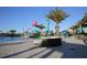 Community pool featuring a splash park with water features, seating, and palm trees under a clear blue sky at 2147 Tripoli Ct, Kissimmee, FL 34747