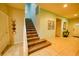 Inviting foyer with a staircase, tiled floors, and decorative wall art, leading to the upper level of the home at 2147 Tripoli Ct, Kissimmee, FL 34747