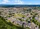Extensive aerial view of a residential community featuring many buildings, grassy area, and a dense tree line in the background at 2322 Silver Palm Dr, Kissimmee, FL 34747