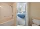 Bathroom with a tub-shower combination, toilet, and view to the next bedroom at 2322 Silver Palm Dr, Kissimmee, FL 34747