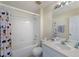 This bathroom boasts a tub with a shower, a single sink, and a unique Mickey Mouse shower curtain at 2322 Silver Palm Dr, Kissimmee, FL 34747