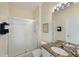 Bathroom boasts granite counters, a white sink, and a glass-enclosed walk-in shower at 2322 Silver Palm Dr, Kissimmee, FL 34747