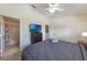 Bedroom has attached bathroom, ceiling fan, wall-mounted television, and a comfortable king-sized bed at 2322 Silver Palm Dr, Kissimmee, FL 34747