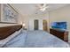 Vaulted-ceiling bedroom boasts an attached bathroom, TV, closet, and a comfortable queen-size bed at 2322 Silver Palm Dr, Kissimmee, FL 34747